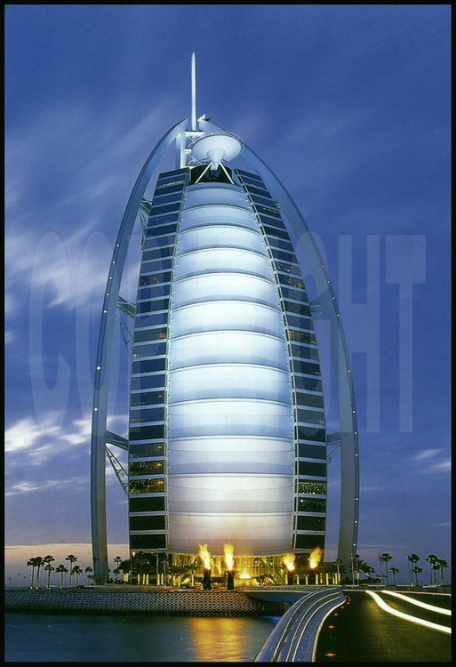 Located on an artificial island 280 meters from the coastline, hotel Burj Al Arab (the “arab tower” in the local language) is the world’s highest hotel at 321 meters, the same height as the Eiffel Tower, and the most luxurious, it is the only one to boast seven stars.  Its shape of a giant sail it has quickly become the emirate’s icon.  It was built in such a way that it never casts a shadow over the beach.  The heliport at the top of this hotel extends past the edges over the ocean.  Its construction, directed by the South-African company Murray& Roberts began in 1994 and its doors opened to the public on December 1st, 1999.  The Burj Al Arab has no rooms, but rather 202 double suites.  The smallest is 196 m2 and the biggest is 780 m2.  Prices vary from 1 000 $ to 6 000 $ per night.  Its entrance hall has one of the world’s largest atriums (180 meters).  The hotel owns a fleet of 10 Rolls-Royces to provide the clientele’s transportation !