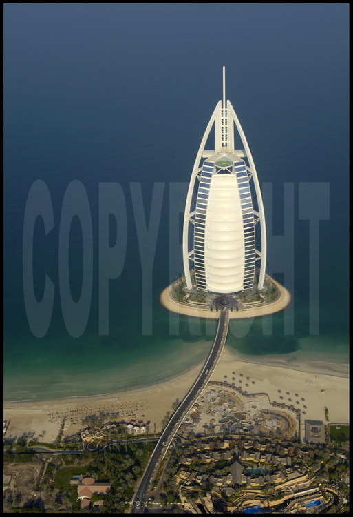 Located on an artificial island 280 meters from the coastline, hotel Burj Al Arab (the “arab tower” in the local language) is the world’s highest hotel at 321 meters, the same height as the Eiffel Tower, and the most luxurious, it is the only one to boast seven stars.  Its shape of a giant sail it has quickly become the emirate’s icon.  It was built in such a way that it never casts a shadow over the beach.  The heliport at the top of this hotel extends past the edges over the ocean.  Its construction, directed by the South-African company Murray& Roberts began in 1994 and its doors opened to the public on December 1st, 1999.  The Burj Al Arab has no rooms, but rather 202 double suites.  The smallest is 196 m2 and the biggest is 780 m2.  Prices vary from 1 000 $ to 6 000 $ per night.  Its entrance hall has one of the world’s largest atriums (180 meters).  The hotel owns a fleet of 10 Rolls-Royces to provide the clientele’s transportation !
