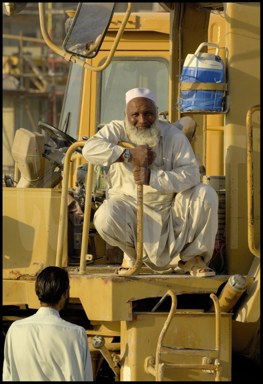 The Sikh caste, privileged among the workers, have assigned themselves the job of driving on the construction site.