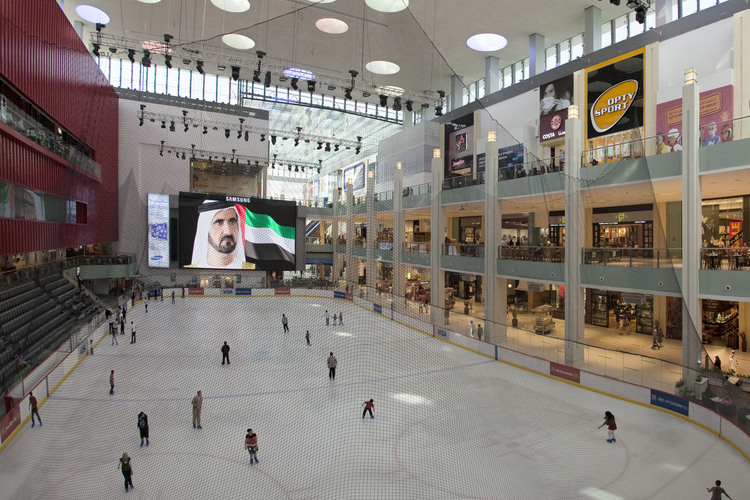 Inside the Dubai Mall (largest mall in the world), the only ice rink in the emirate. In the background, the portrait of Sheikh Ahmed Al Maktoum, omnipotent ruler of Dubai.