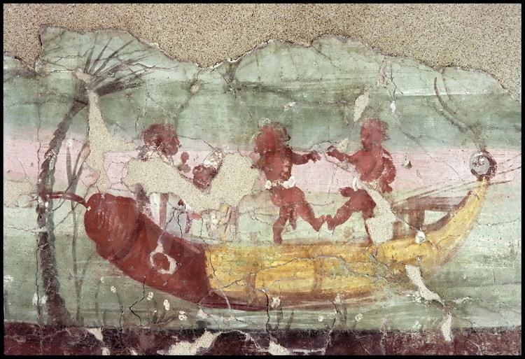 This scene, which is a part of the long Nile frieze on the peristyle of the House of the Sculptor, was easily visible to passers-by.  It shows naked pigmies dancing on a papyrus barque with a bow in the shape of a phallus.  The phallus’ “stream”, an original and witty detail, directed towards the two ducks (not visible in this photo), was certainly intended to make onlookers laugh.