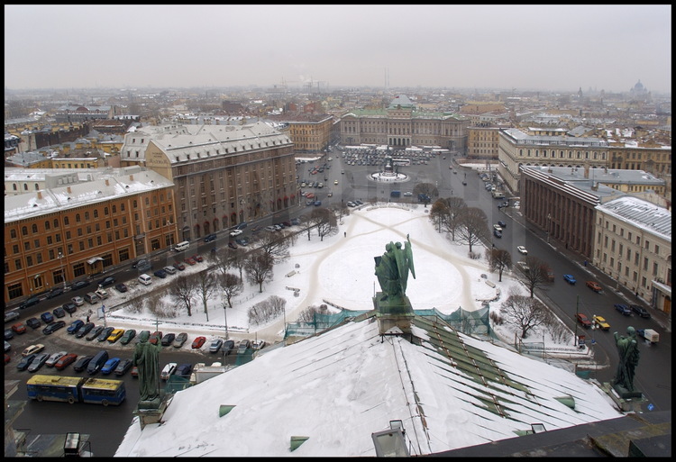 Aerial view of Saint Isaac's Place from the cathedral's dome.  In the 
background, the equestrian statue of Nicholas the 1st and the Marinski 
Palace; so baptized in honor of the tzar's daughter, it is still home to St 
Petersburg's Town Hall.