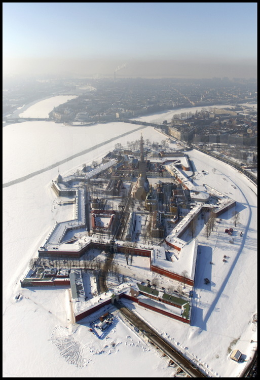 Aerial view of the Peter and Paul Fortress.  Its construction in 1703, 
decided on by Peter the Great, is St Petersburg's birth certificate.  The 
first wooden citadel was replaced with stone according to Italian architect 
Domenico Trezzini's plans.  At the center of the fortress, the Saint Peter 
and Saint Paul Cathedral.  In the background from left to right:  the 
Admiralty, the Strelka (the tip) of Vassilievski Island with the Marine 
Museum and the Rostral Columns, Petrograd, the city's first neighborhood also 
founded in 1703.