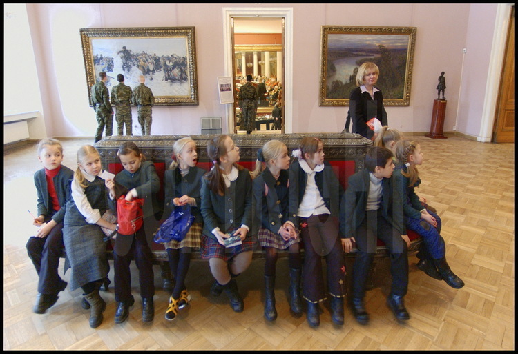 Russian Museum.  A class of a Russian all girls school with their teacher 
visits the 19th Century Russian paintings rooms.  In the background, a group 
of young Russian military men.