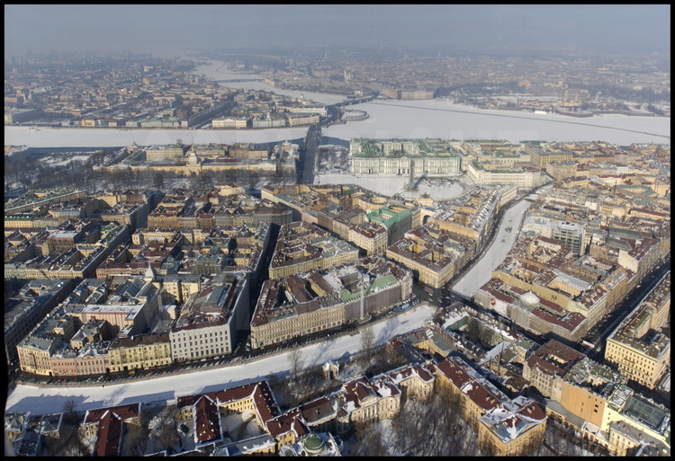 Aerial view of the city center.  In the foreground, the Moïka Canal cuts 
across the Nevsky, the most famous avenue of Russia.  In the middle from left 
to right:  Decabrist Place, the Admiralty, the Hermitage and the Winter 
Palace, Palace Place and the Alexandre Column, the general army headquarters.  
In the background, from left to right:  Vassilievski Island and the Strelka 
(the tip) with the Academy of Sciences, the Kounskamera, the Marine Museum, 
the Rostral Columns, the Dvortsovy Bridge, Petrograd, the city's first 
quarter founded in 1703, the Peter and Paul Fortress with the cathedral of 
the same name.