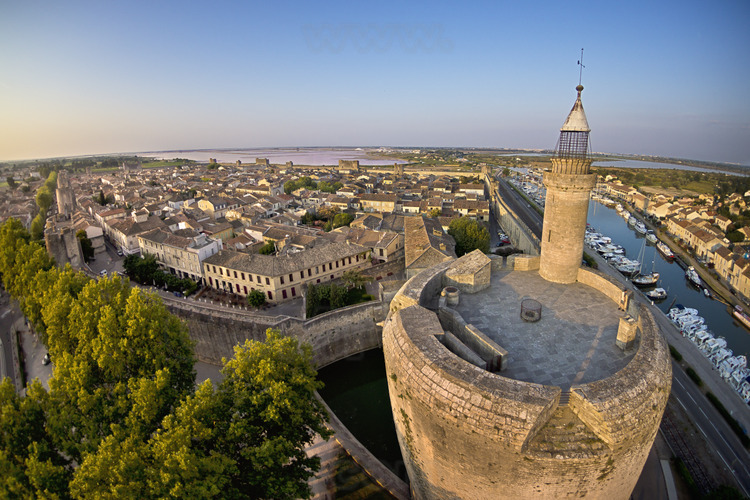 Top of the tower of Constance seen from the north. In the background, the walled city and the Salins du Midi (purplish in summer).