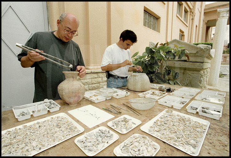 Cremation specialists, archeologists Gilles Grévin (left) and Paul Bailet (right), from the University of Draguignan, extract entire skeletons from cinerary vases called “Hadra’s Hydria” discovered on the digging site of ancient Necropolis.