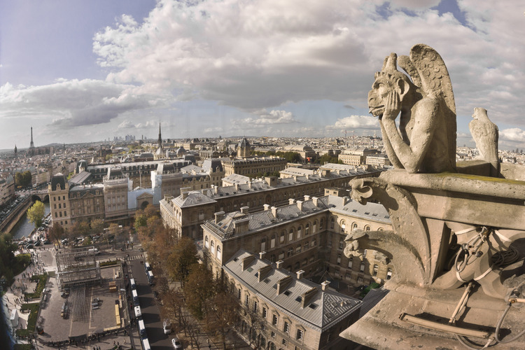 At the height of the great gallery of chimeras and gargoyles, which connects the base of the towers. Built 150 years ago, this scary bestiary came out of the imagination of the architect Viollet le Duc and is now part of the image of Notre Dame. Here, the famous Stryge of the north tower. In the background, l. to r., the Invalides, the Eiffel Tower, the south arm of the Seine, the Prefecture of Police, Defense district, Sainte Chapelle, the Palais de Justice and the Châtelet. Altitude 43 meters.