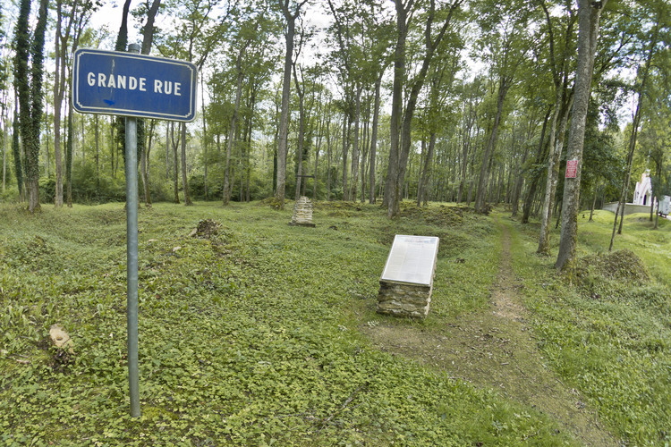 Battle of Verdun: Destroyed village of Bezonvaux, the former main street. The locations of the houses have been materialized by milestones reminding trades and activities of the former village community. Included in the 