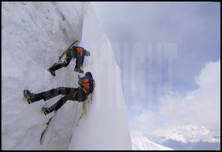Equiped with high mountain gears, technicians of Andermatt city are climbing along Gemsstock glacier face to fix precisely the different parts of the fabric (each roll is 5 meters large).