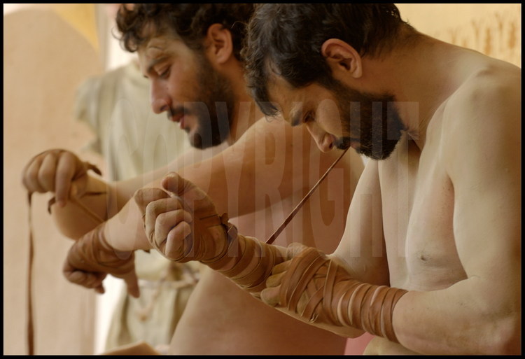 Under the palestra’s colonnades, athletes in experimental archaeology Pierre Dufour (left) and Brice Lopez (right) wear the leather straps identical to those used in Antiquity for the fight training and competition.