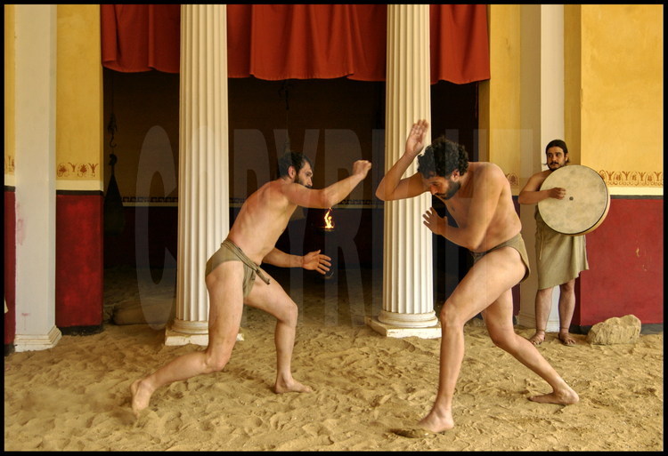 Under the palestra’s colonnades, athletes in experimental archaeology Pierre Dufour (left) and Brice Lopez (right) train for the pancratium competition to the sound of the tambourine.