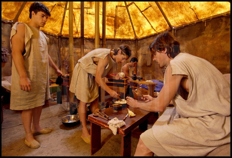 Not far from the palestra, participants stayed in a camp which identically recreated their ancestor’s living conditions.  Inside their tent, Spanish athletes have a copious breakfast before their morning training, as their ancestors did. On the left, Antonio Ledesma, in the middle, Ron Guttierrez, on the right, Jordi Mayoral.