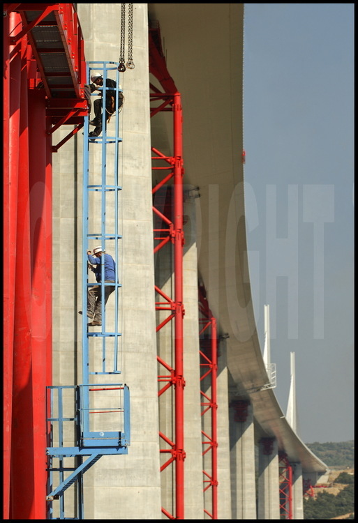 Below the roadway of the bridge, workers are beggining to remove the temporary and intermediary pylons (in red) which helped during the building of  the bridge.
