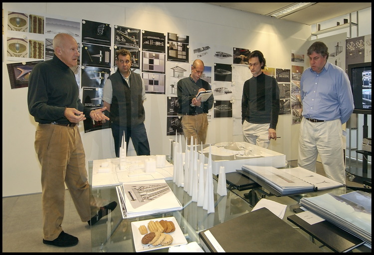 In his offices in the district of Battersea in London, Sir Norman Foster is studying new projects with architects colleagues. On the background, draws of the future Bejing Airport which will be completed before the 2008 Olympic Games. On the right foreground, the project of a huge congress center dedicated to Russia.