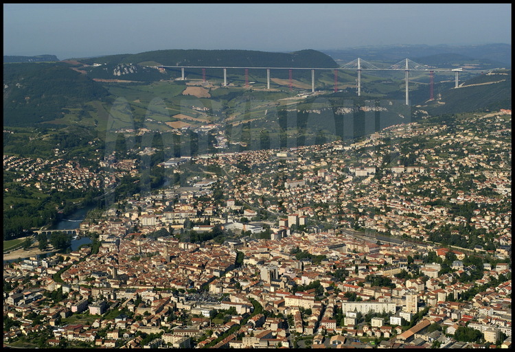 June 2004.  The city of Millau and the viaduct seen from the summit of Puech Nègre, east of Millau.  On the left, the Larzac Limestone Plateau.
