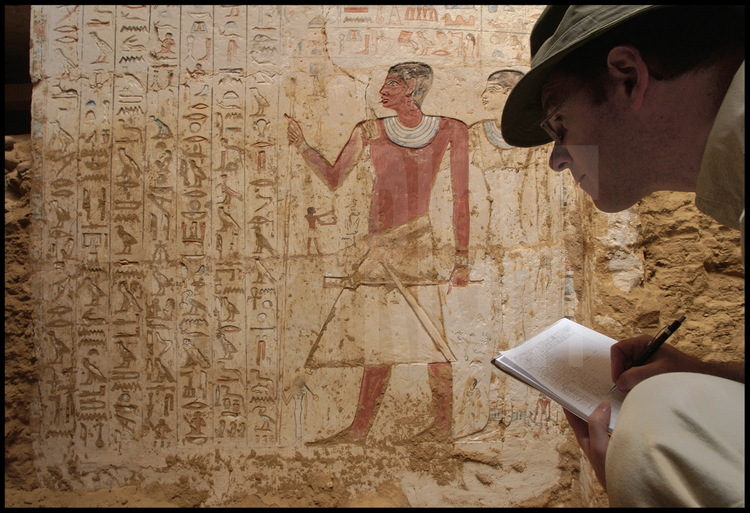 Bernard Mathieu copies down a particularly important hieroglyphic text engraved on the North wall of the painted façade. This inscription is in two parts and seems to come directly from Hau-Nefer. . In the first section, the inscription tells visitors to honor and respect the tomb and the defunct by reciting the offering prayer: “A thousand breads, a thousand pots of beer for the owner of this tomb, and all that he may lay his hands upon”. The second section, however, warns the disrespectful intruder with the following threat: “He who comes to take but one stone or one brick from this tomb will be judged with me at the court of the Great God Osiris and he will get his dues! This will be seen by all the living and known by all the dead!” It is therefore ironic that Hau-Nefer himself took apart other tombs to build his own…Obviously desecration has always been a hard principle to follow. But beware of this threat come from the other side – does it not call to mind the famous curse of the tomb of Tutankhamon?