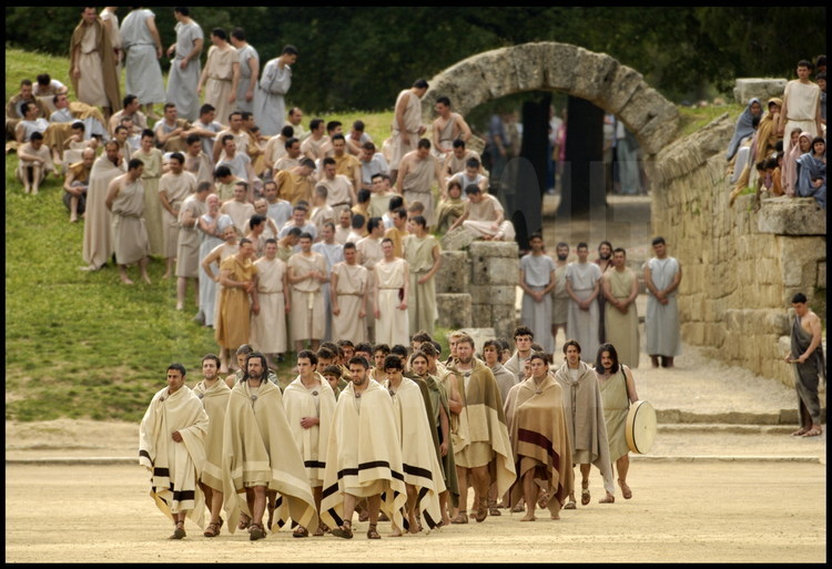 Opening ceremony for the ancient Games: once the hellanodices and athletes have entered the stadium by the crypt(today a partially destroyed tunnel) only accessible to them, they introduce themselves to the audience and officials as a delegation.  In the foreground, the Greek delegation.